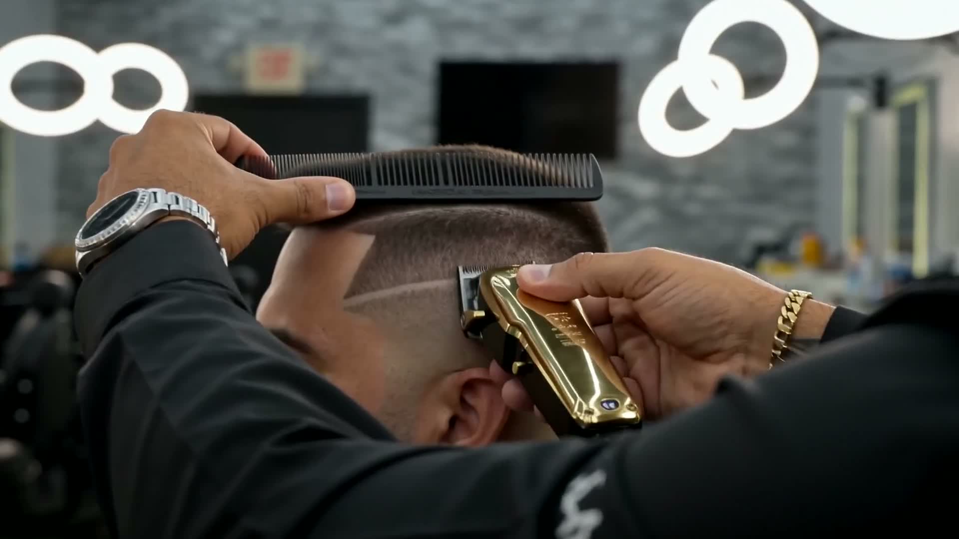 Barber making a precise clipper pass on a fresh haircut